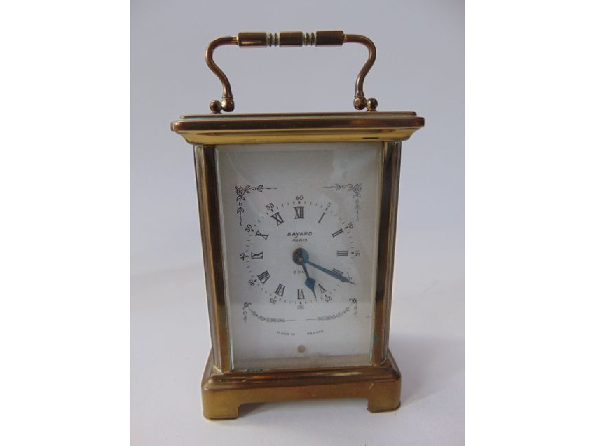 Appraisal: A brass framed French carriage clock with bevelled glazed panelled