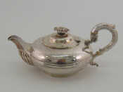 Appraisal: A William IV silver compressed globe teapot with half ribbed