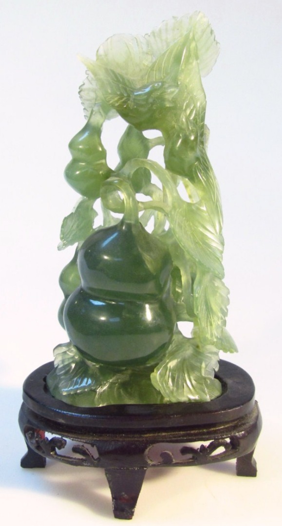 Appraisal: A thC Chinese dark green jade carving of birds and