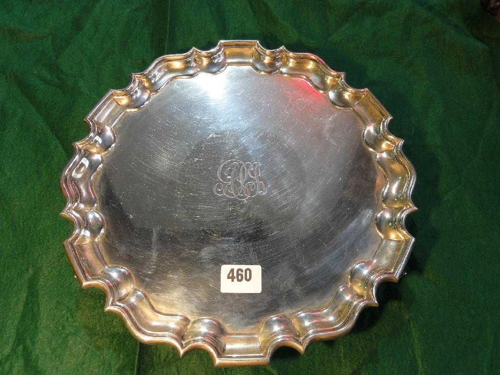 Appraisal: A silver salver with raised pie crust border on scrolled