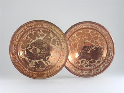 Appraisal: Two similar Hispano-Moresque dishes each decorated in copper lustre with