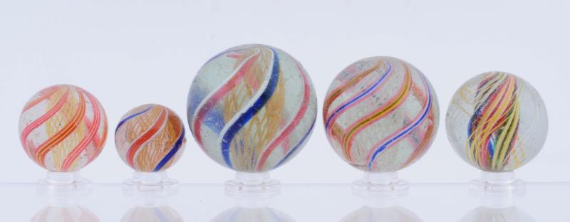 Appraisal: Lot Of Swirl Marbles Lot includes three yellow and one