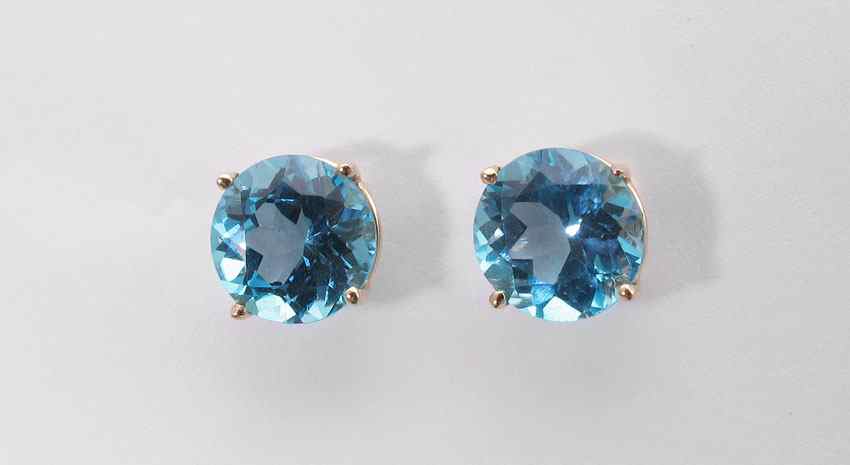 Appraisal: BLUE TOPAZ EARRINGS K yellow gold earrings contains round shaped