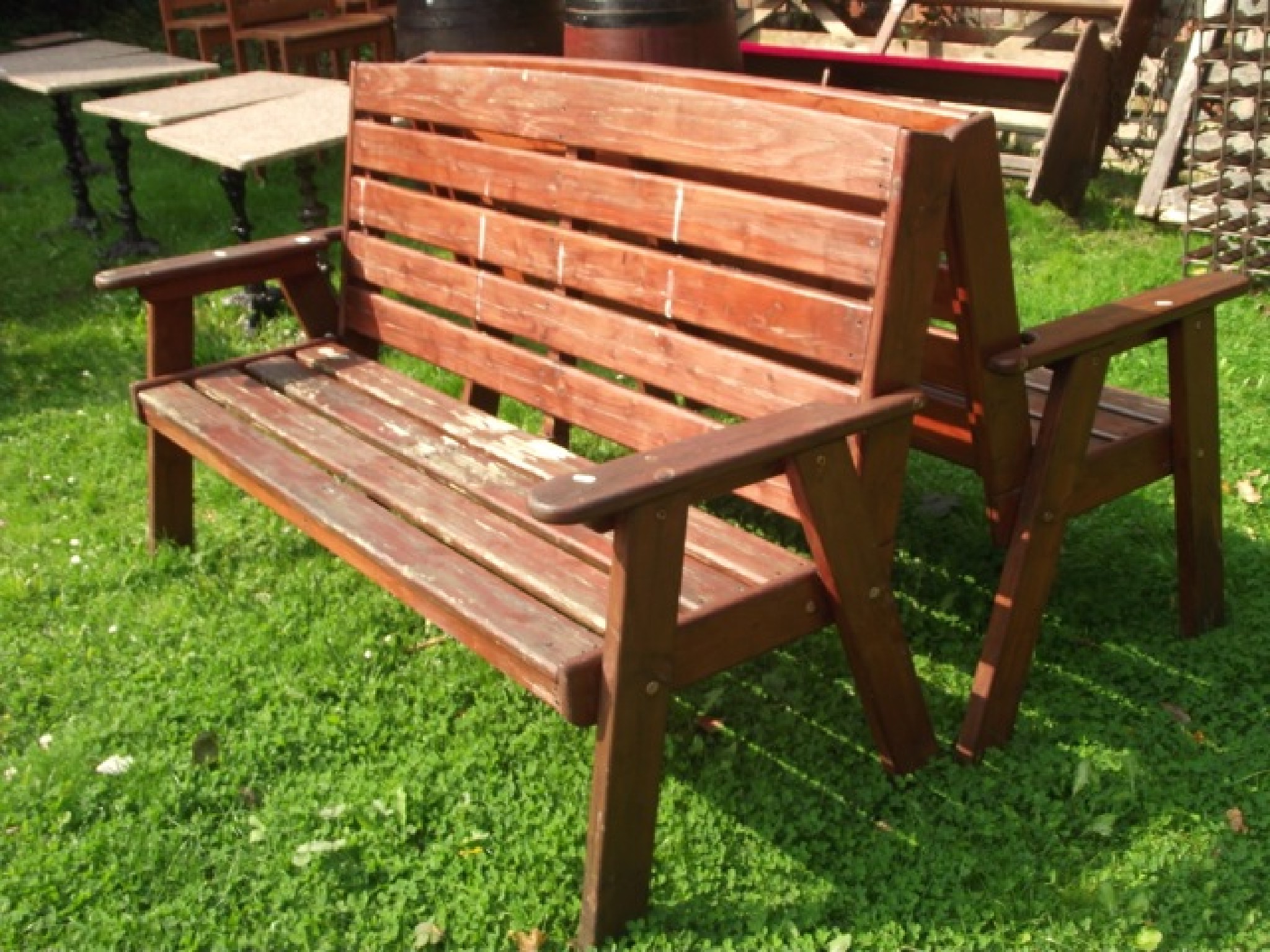 Appraisal: A pair of three seat garden benches