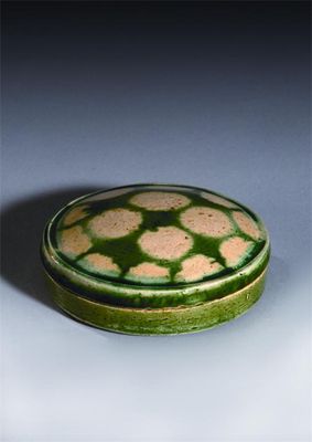 Appraisal: A Chinese pottery sancai-glazed spotted circular box and cover Tang