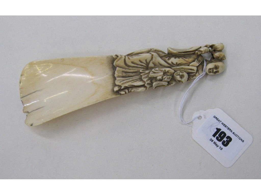 Appraisal: Carved ivory shoe horn with figural handle