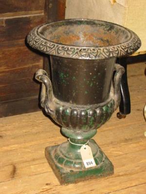 Appraisal: A CAST IRON GARDEN URN of semi lobed campagna form