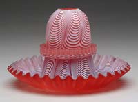 Appraisal: NAILSEA DRAGLOOP FAIRYLAMP Cranberry glass with white dragloops consisting of