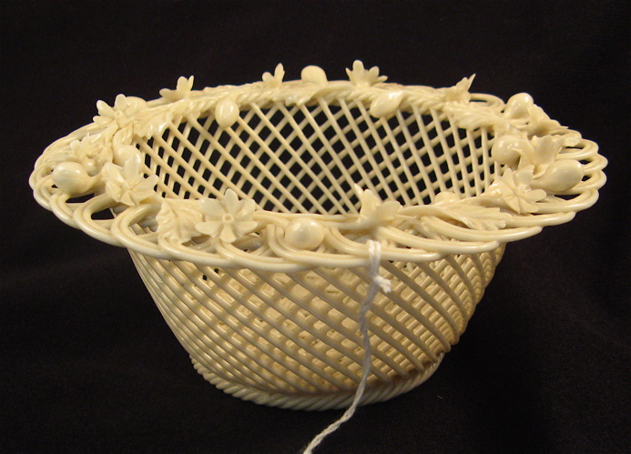 Appraisal: AN IRISH BELLEEK PORCELAIN BOWL in basket weave with four