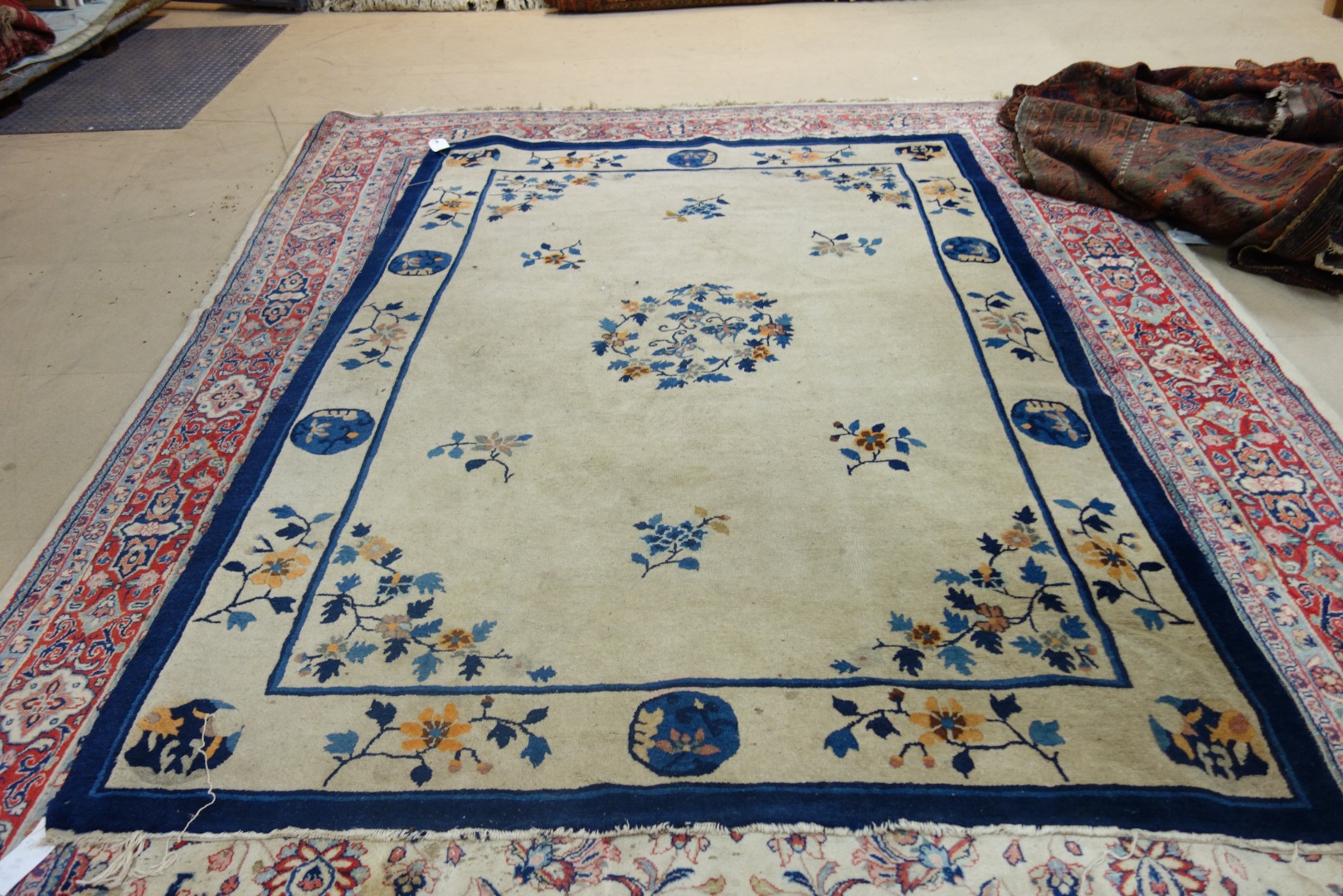 Appraisal: A Chinese rug the plain natural field with a roundel