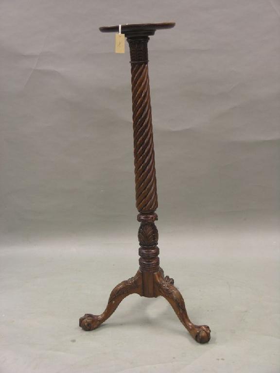 Appraisal: A mahogany torchere dished circular top on spiral turned stem