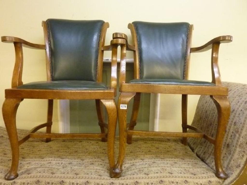 Appraisal: A pair of oak framed open elbow desk chairs with