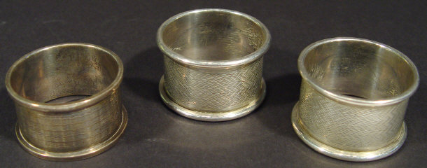 Appraisal: Pair of engine turned silver napkin rings Birmingham and one