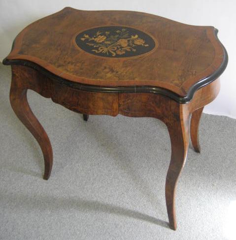 Appraisal: A VICTORIAN WALNUT AND EBONISED LOUIS XV STYLE CENTRE TABLE