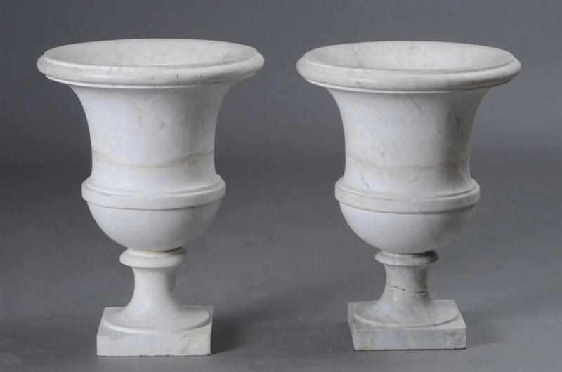 Appraisal: PAIR OF NEOCLASSICAL STYLE CARVED WHITE MARBLE URNS Of belted