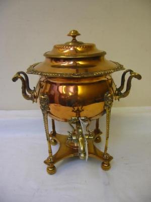 Appraisal: A COPPER AND BRASS TEA URN of circular form raised