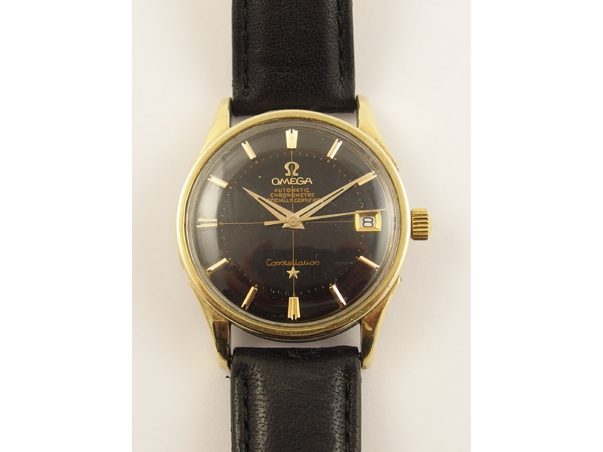 Appraisal: An Omega constellationautomatic Chronometer black dial with date aperture gold