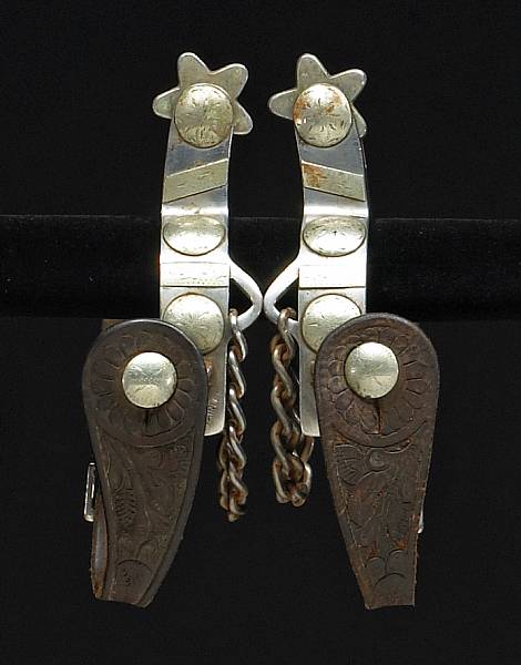 Appraisal: A pair of silver-mounted Crockett bronc spurs Single mounts set