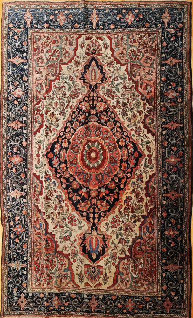 Appraisal: PERSIAN SAROUK CARPET The brick and indigo medallion anchored in