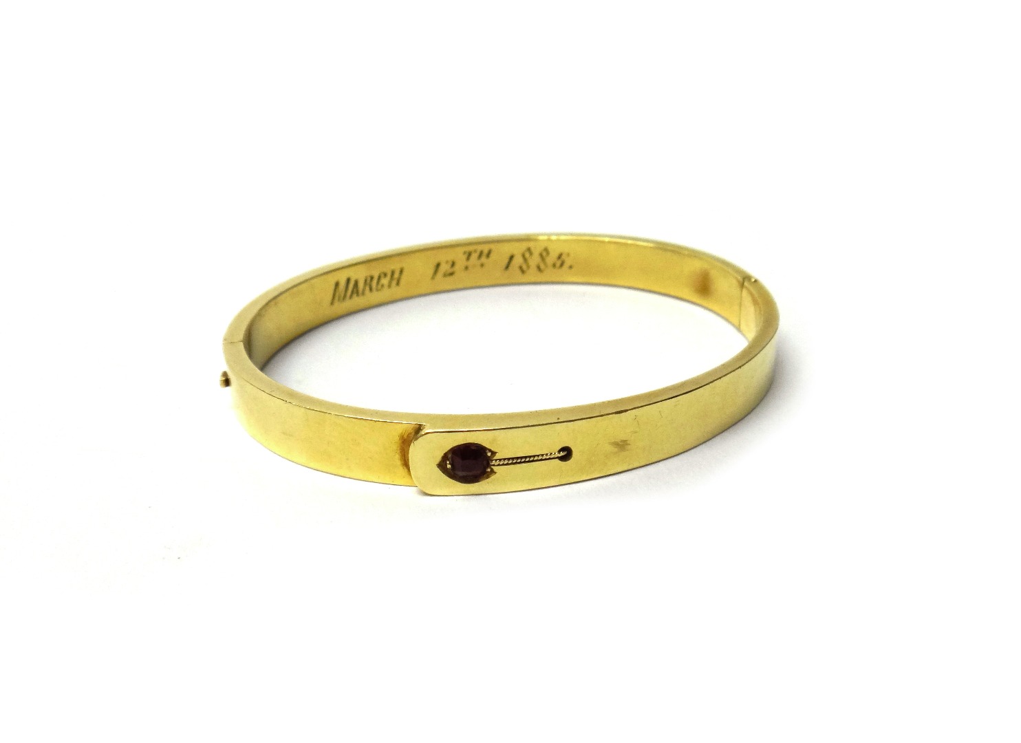 Appraisal: A Victorian gold and garnet set oval hinged bangle in