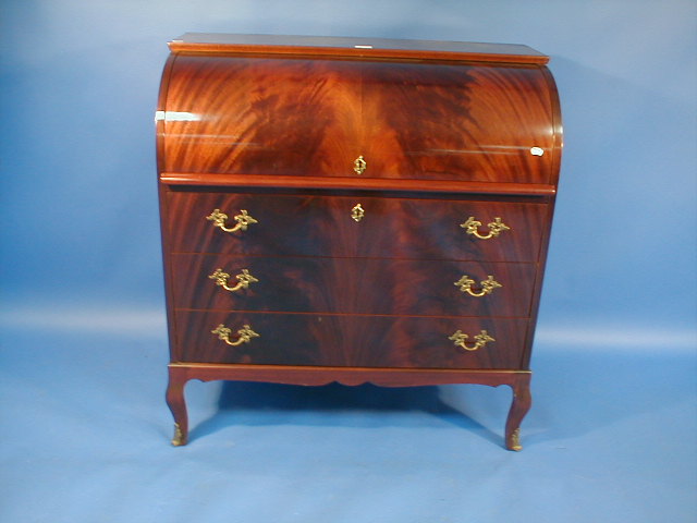 Appraisal: A reproduction flamed mahogany cylinder bureau