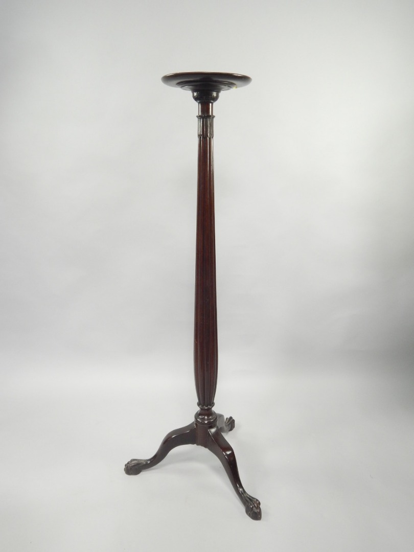 Appraisal: A mahogany torchere with circular platform top and tapered reeded