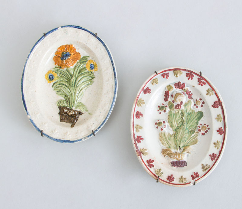 Appraisal: TWO ENGLISH CREAMWARE RELIEF-DECORATED MINIATURE OVAL PLATTERS Each with flower-filled