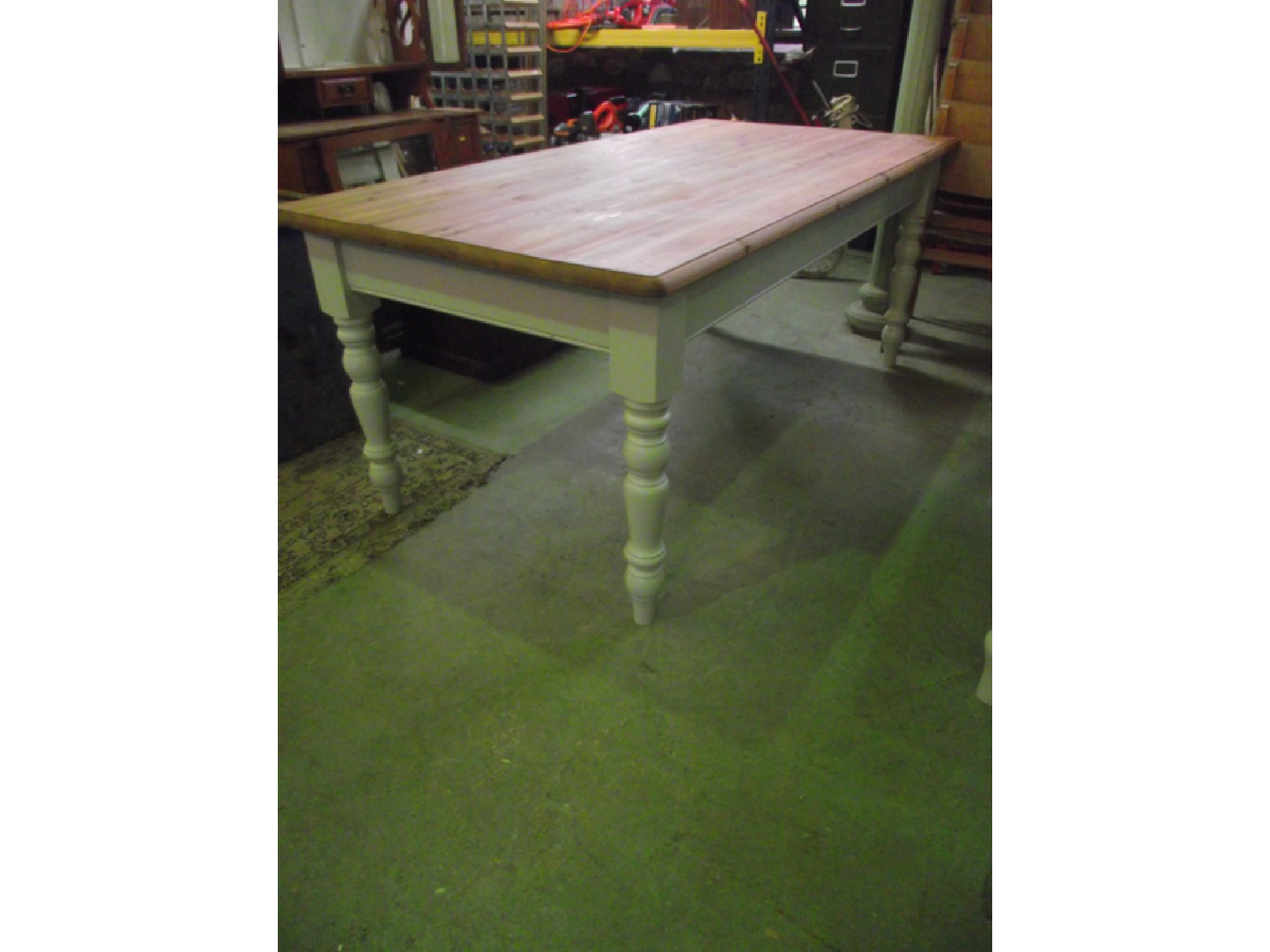 Appraisal: A pine farmhouse table with plank top raised on a