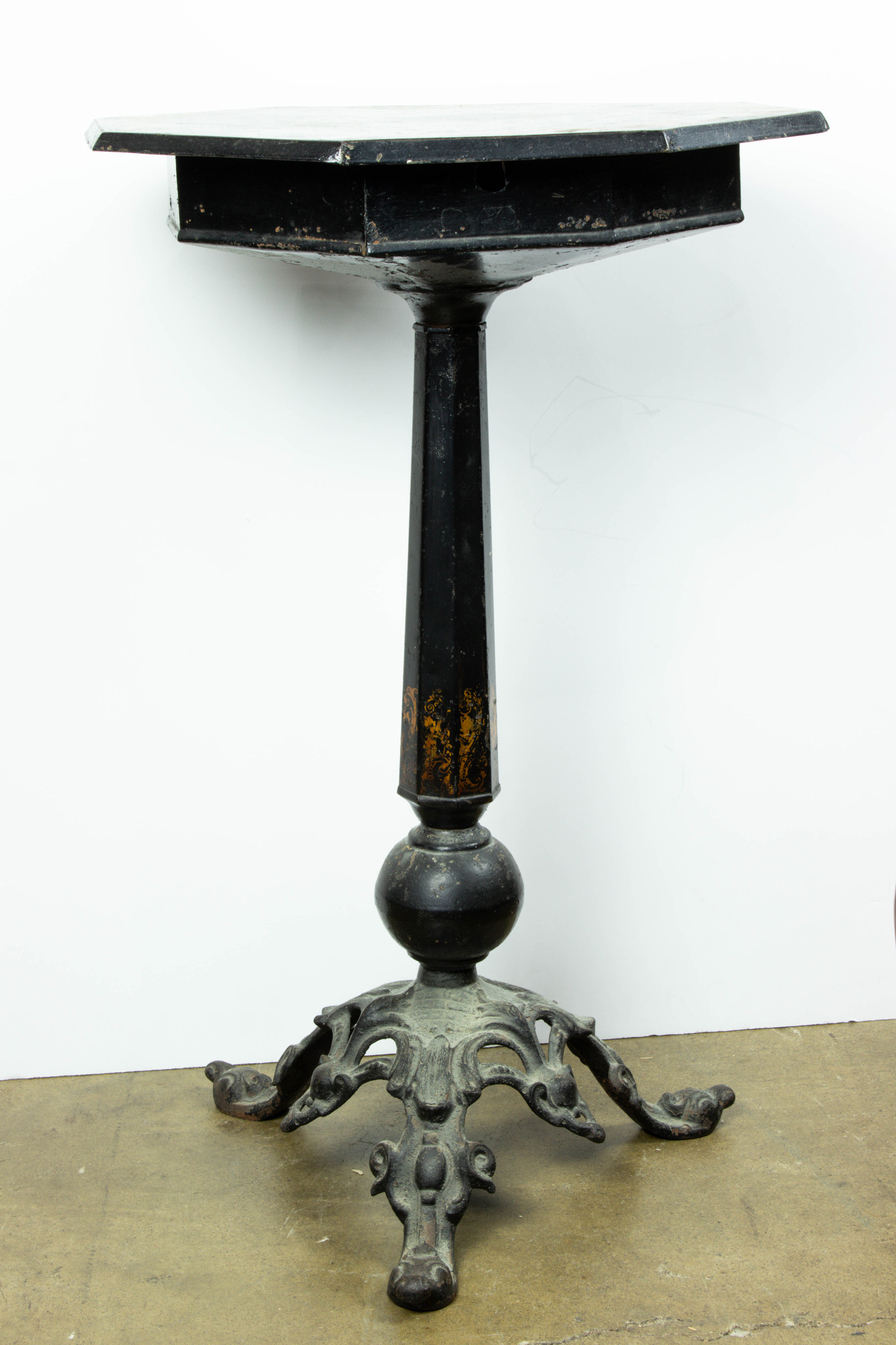 Appraisal: TOLE AND CAST IRON OCTAGONAL PEDESTAL TABLE Tole and cast