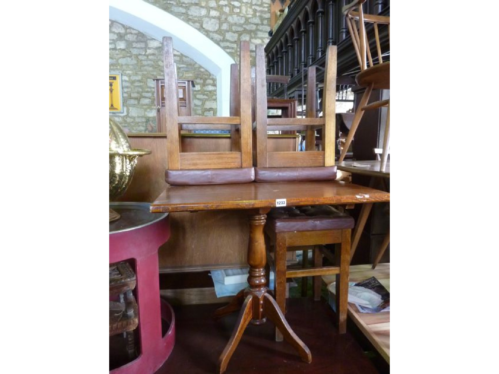 Appraisal: A pub table on turned pillar and quadruped base together