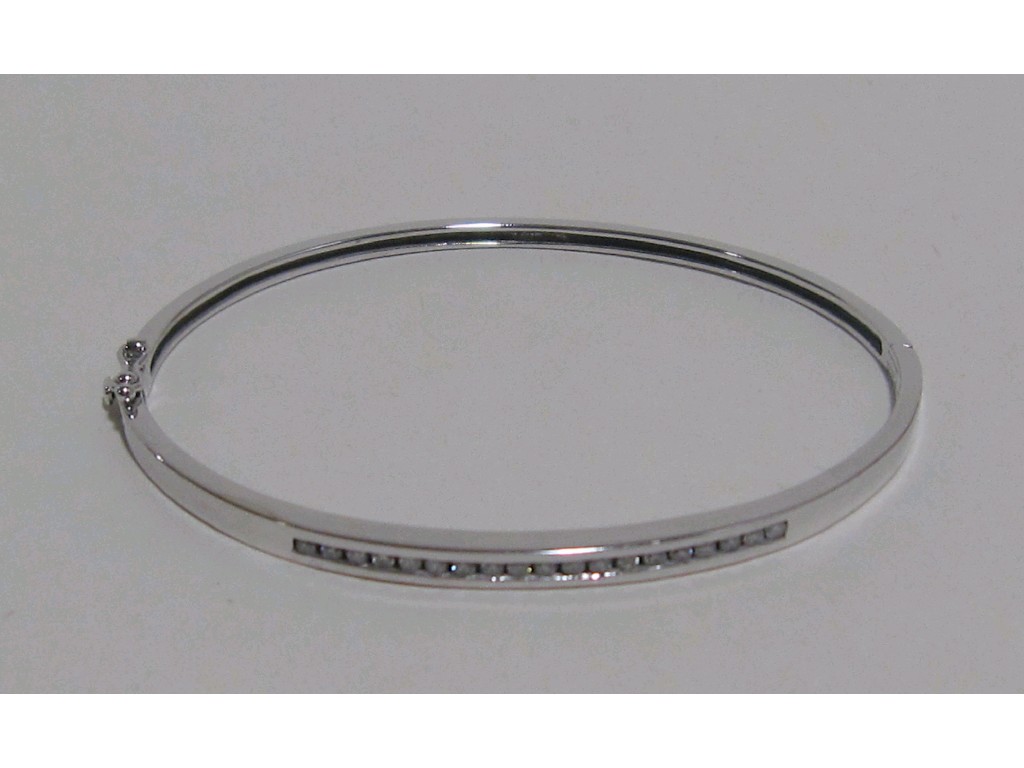 Appraisal: Nine carat white gold channel set diamond bangle