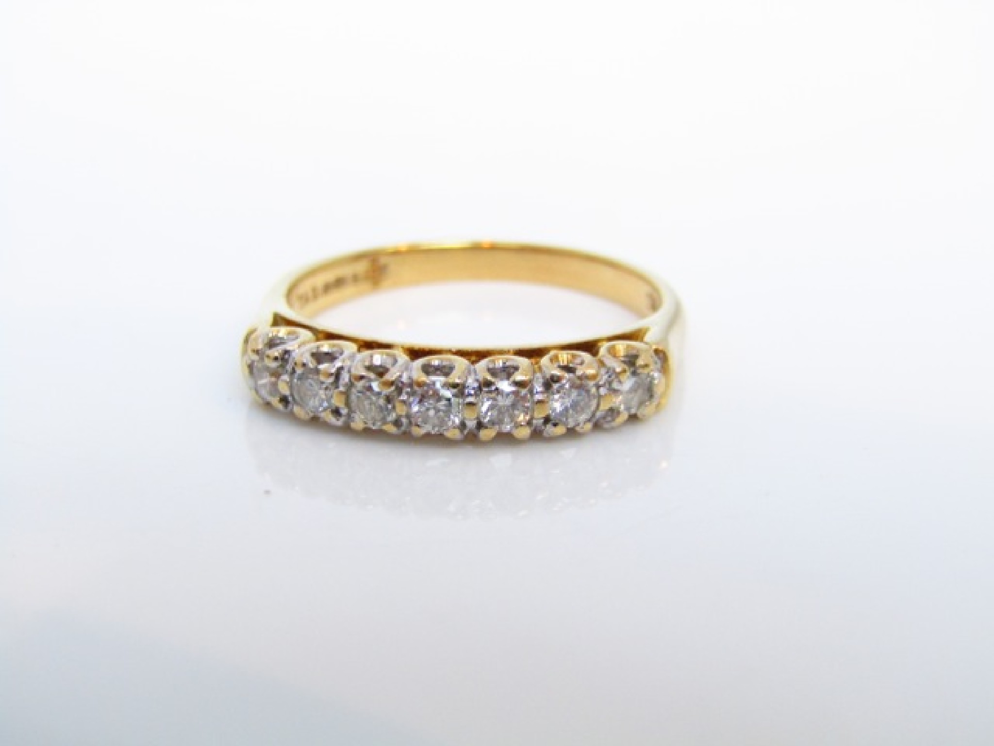 Appraisal: A seven stone diamond ring set with round brilliant-cut diamonds