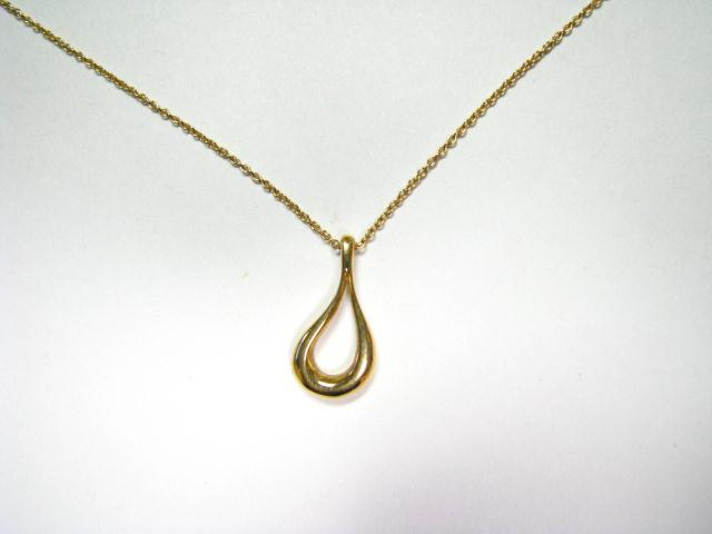 Appraisal: Tiffany K yellow gold teardrop pendant and chain