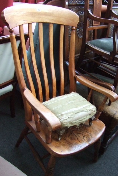 Appraisal: A Victorian beech and elm stick back open armchair raised