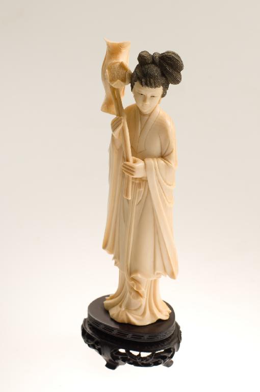 Appraisal: CARVED IVORY FIGURE OF THE TAOIST IMMORTAL HO mounted on