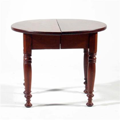 Appraisal: Walnut side table Round top over straight skirt turned legs