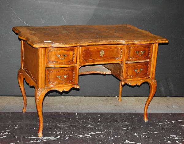 Appraisal: An Italian Rococo style walnut kneehole desk composed of antique