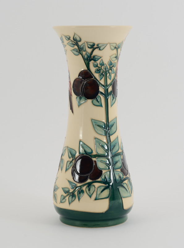 Appraisal: MOORCROFT POTTERY VASE With bird and fruit tree decoration Impressed