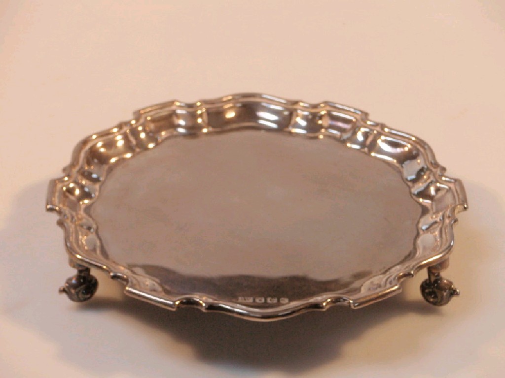 Appraisal: A small circular salver with Chippendale moulded border on three