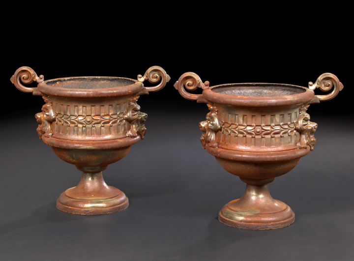 Appraisal: Large Pair of Continental Cast-Iron Animal Masque-Handled Footed Garden Urns