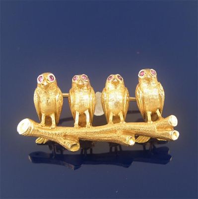 Appraisal: A gold brooch modelled as four birds perched on a