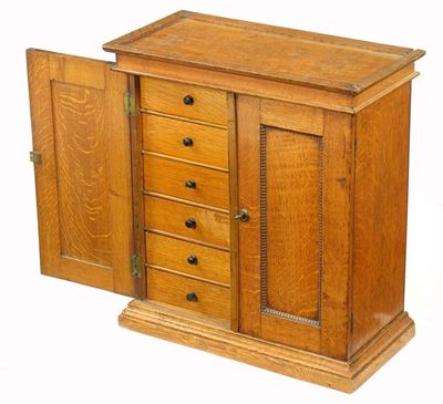 Appraisal: A Victorian oak table top collector's cabinet with a pair