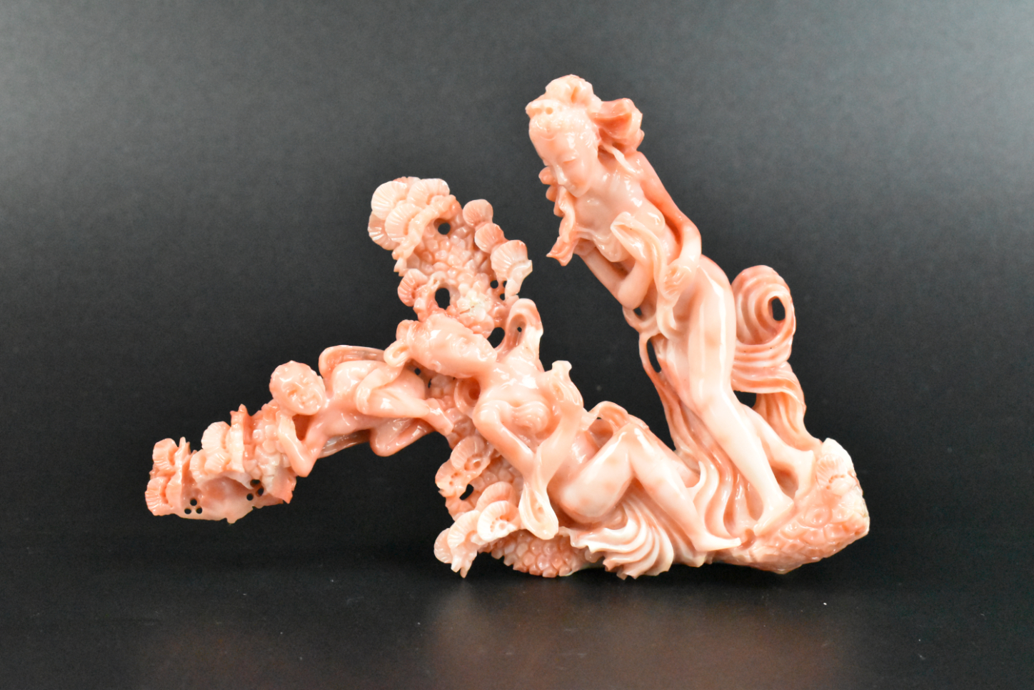 Appraisal: A Chinese carving of figures in red coral The unique