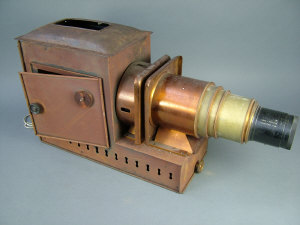 Appraisal: A copper and brass finished projector with a inch focus