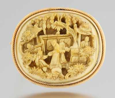 Appraisal: A Carved Ivory Brooch Tested k yellow gold twist frame