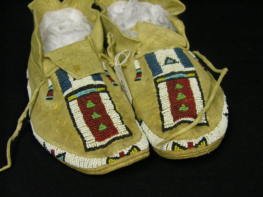 Appraisal: NATIVE AMERICAN BEADED MOCCASINS Brain tanned leather hard soles beaded