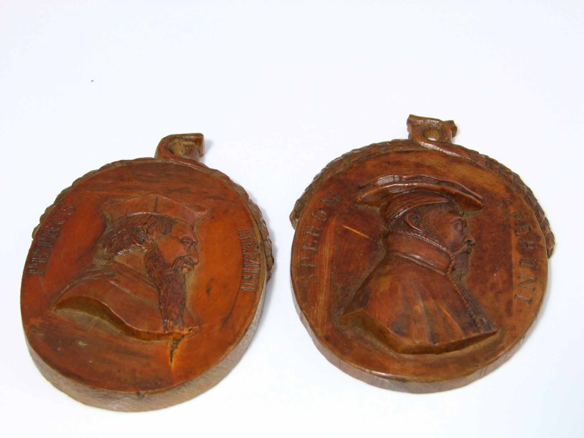 Appraisal: Two th century oval olive wood panels with relief portraits