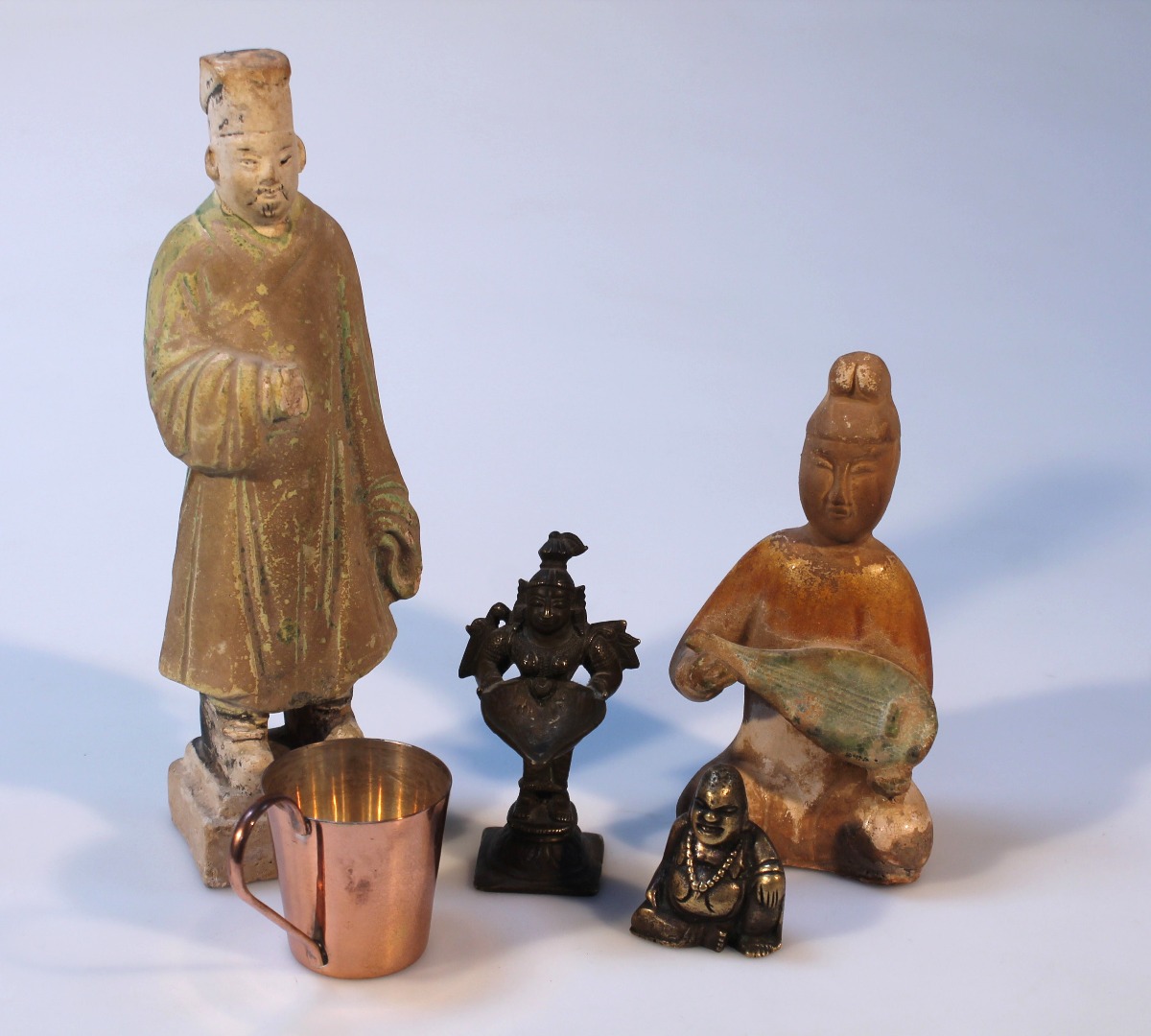 Appraisal: Various oriental figures to include a Chinese stoneware figure of