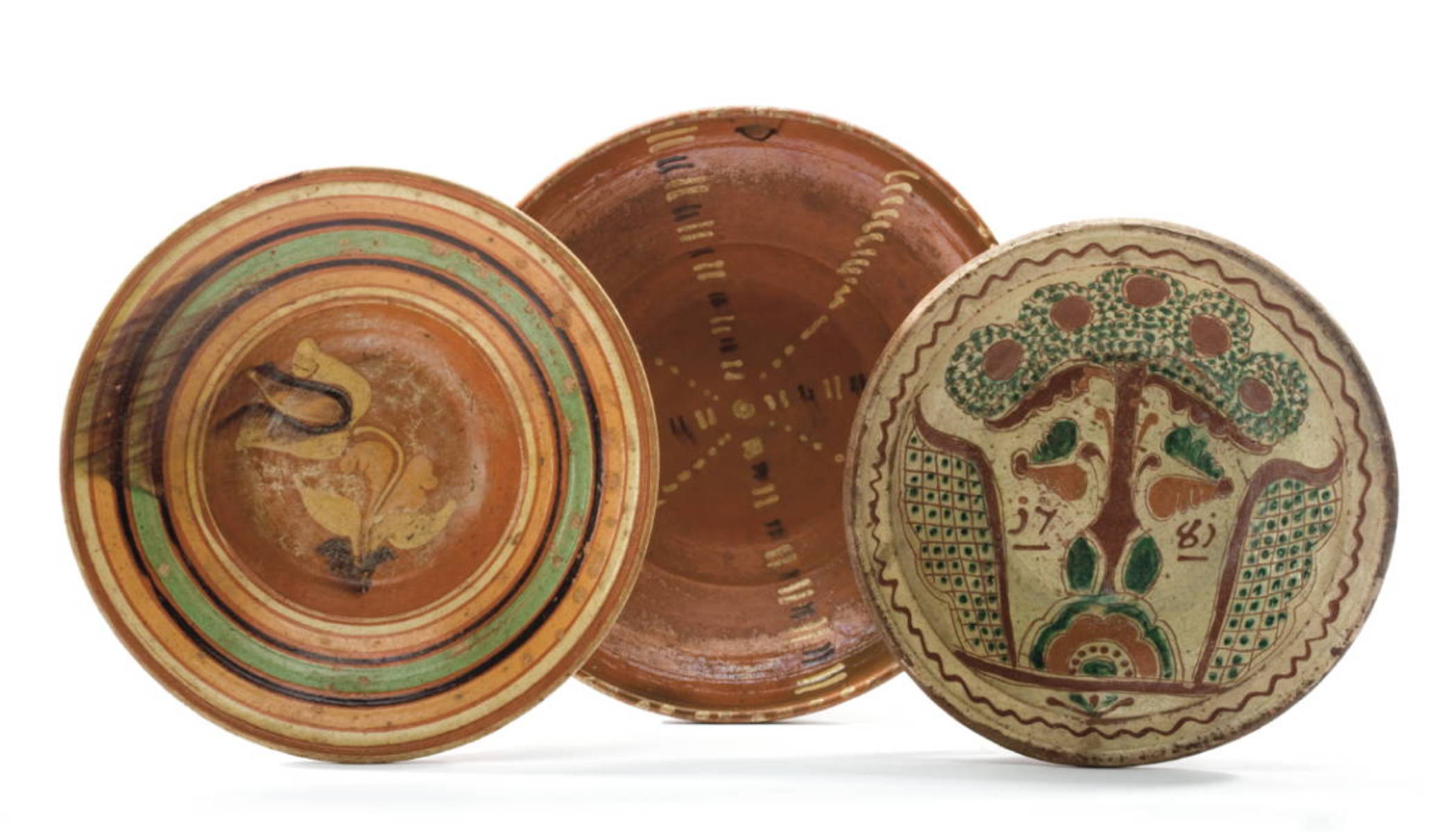 Appraisal: THREE CONTINENTAL SLIP-DECORATED REDWARE DISHES The first decorated in cream