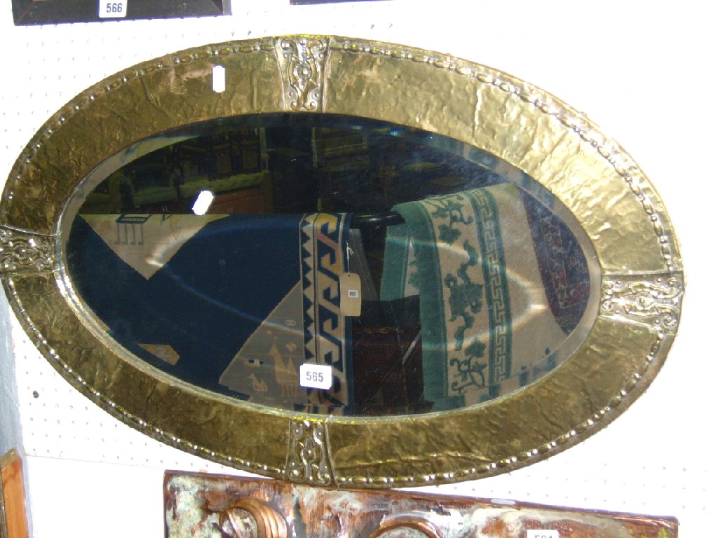 Appraisal: An Arts Crafts brass framed wall mirror of oval form